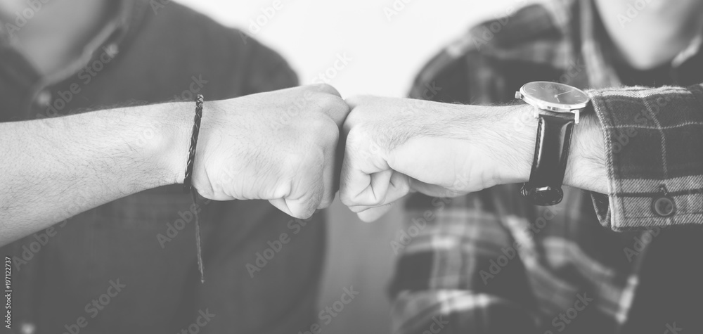 Closeup of men fist bumping