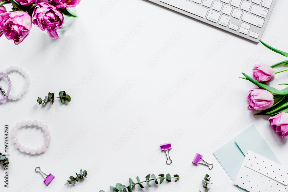 Spring flowers on workdesk at home white background top view moc