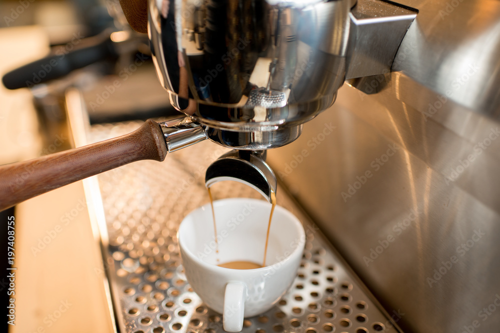 Close-up view on the professional coffee machine making espresso