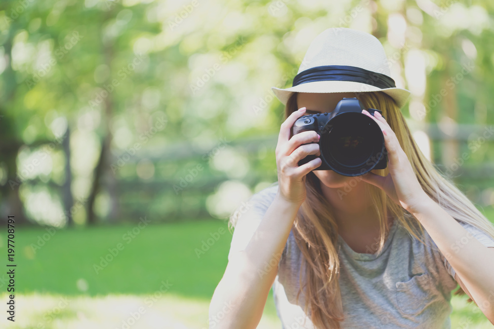 Female photographer with a DSLR camera outside