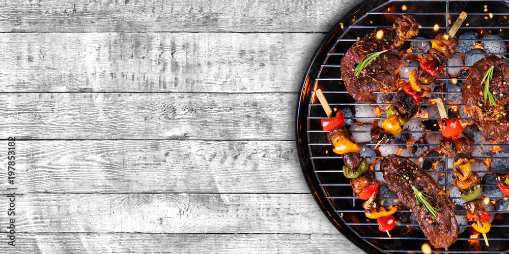 Top view of fresh meat and vegetable on grill placed on wood