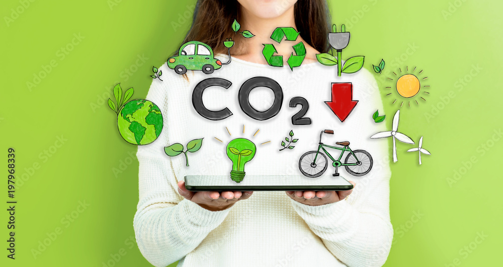 Reduce CO2 with woman holding a tablet computer