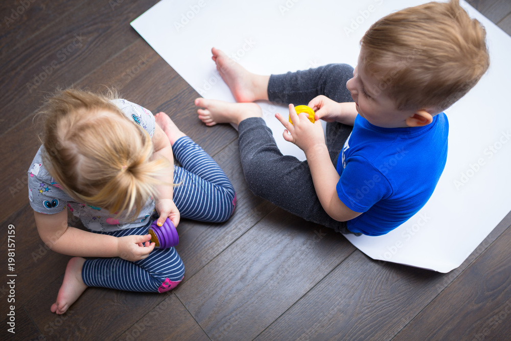 Brother and sister twins learn how to paint by hands