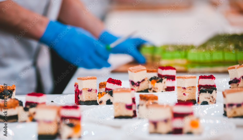 Different types of cakes on plates prepared in pastry shop