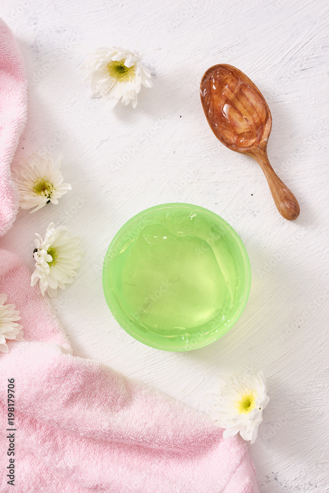 spa setting with cosmetic gel, leaves on white table background