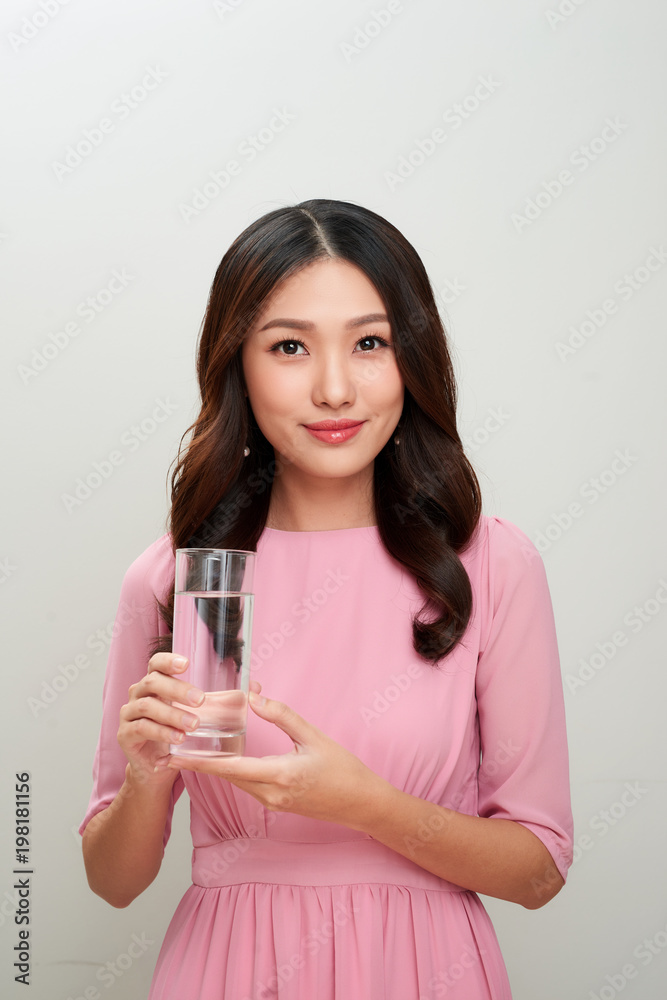 Young asian beautiful woman showing the glass of water.