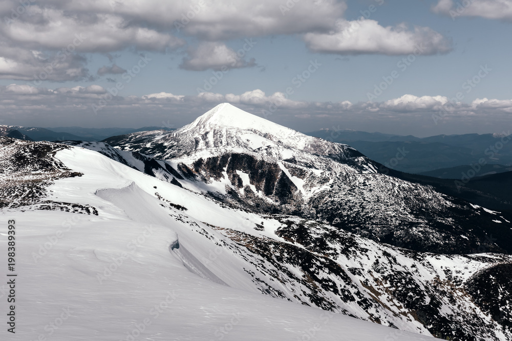 Fantastic spring landscape with snow mountain glowing by sunlight. Carpathian mountains. Travel vaca