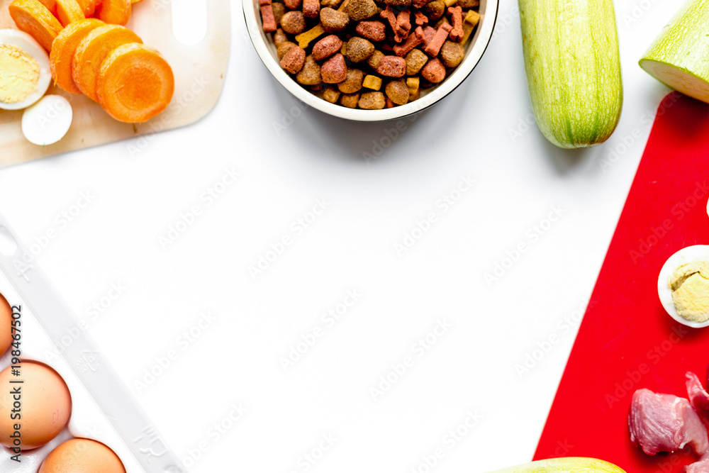 sliced vegetables and petfood on kitchen table background top vi