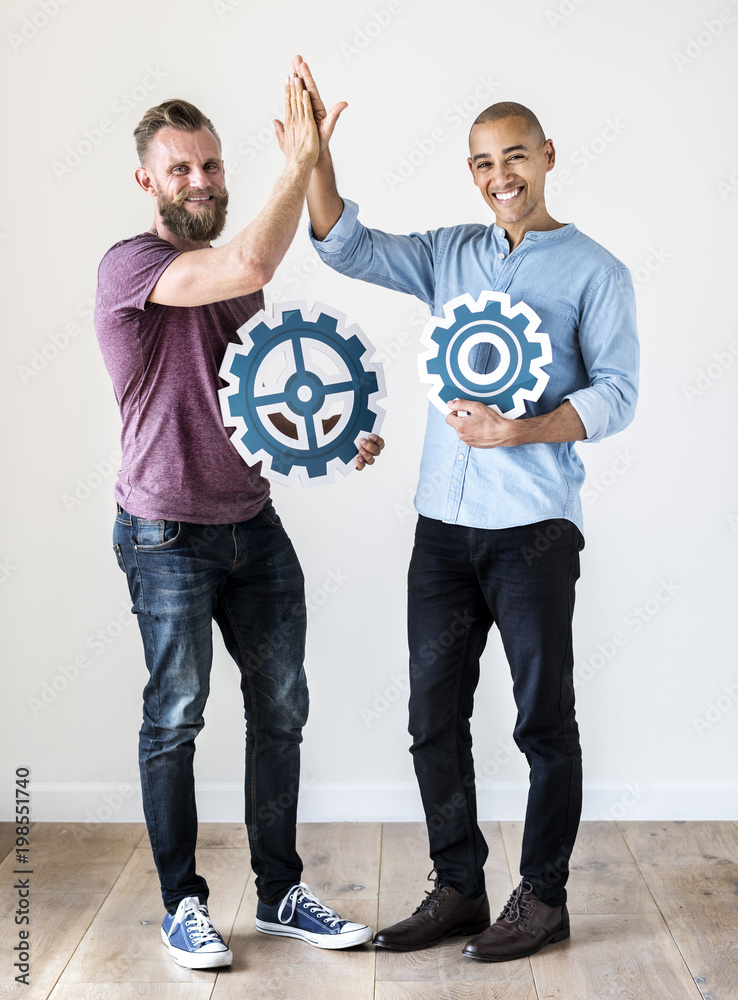 Two casual man holding cog icon