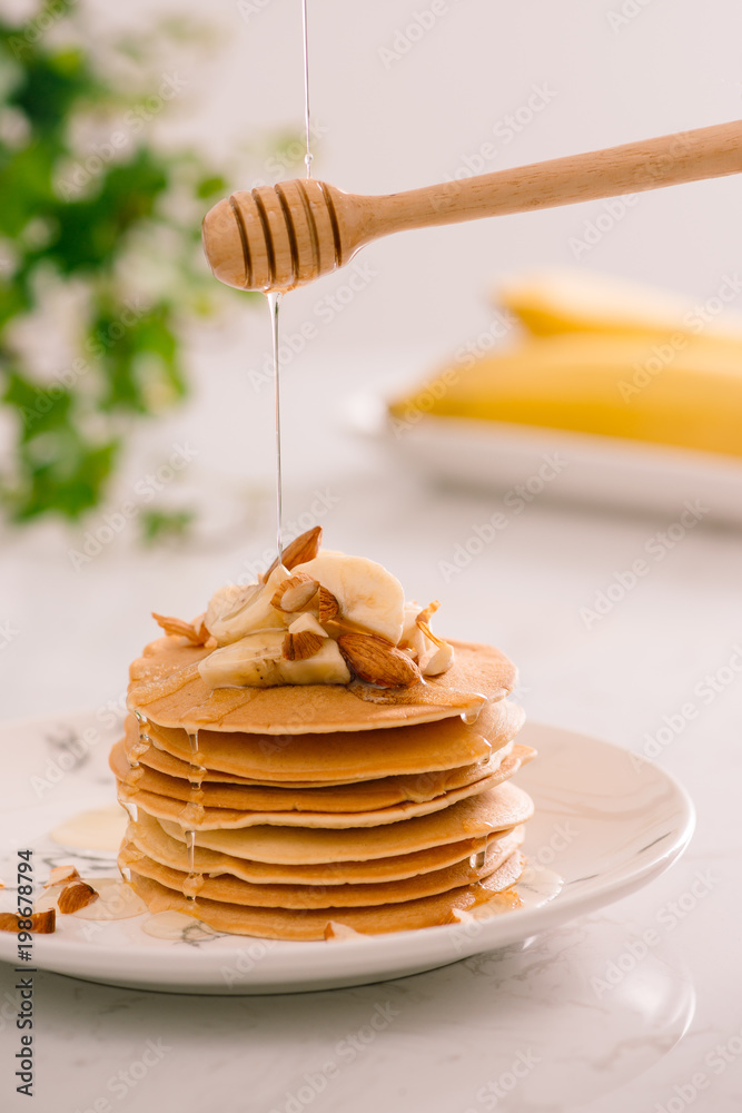 Banana cashew pancakes with bananas and caramel sauce.