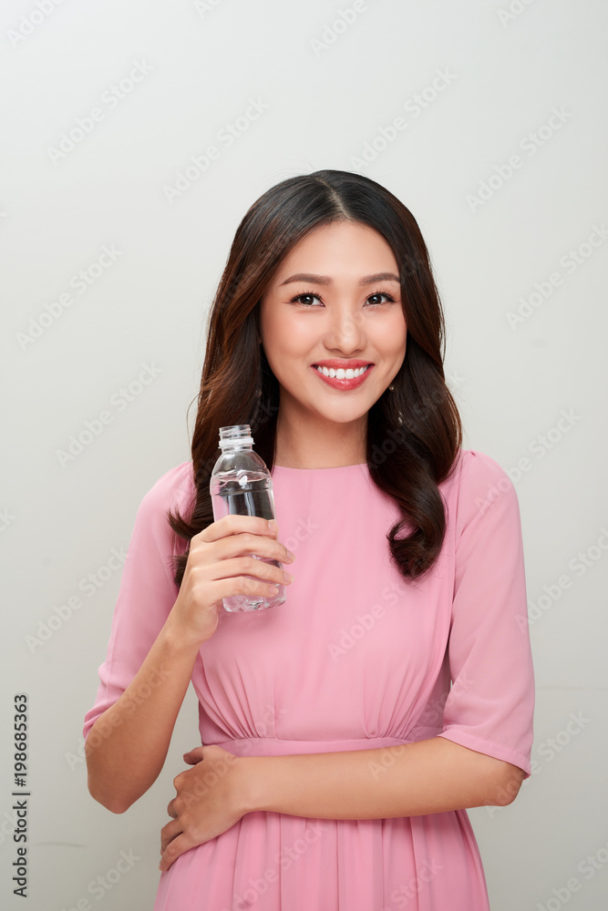 Young asian beautiful woman showing the glass of water.