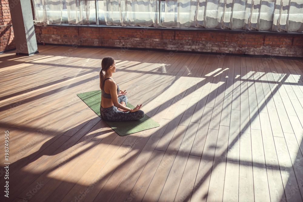 Young girl in a lotus position