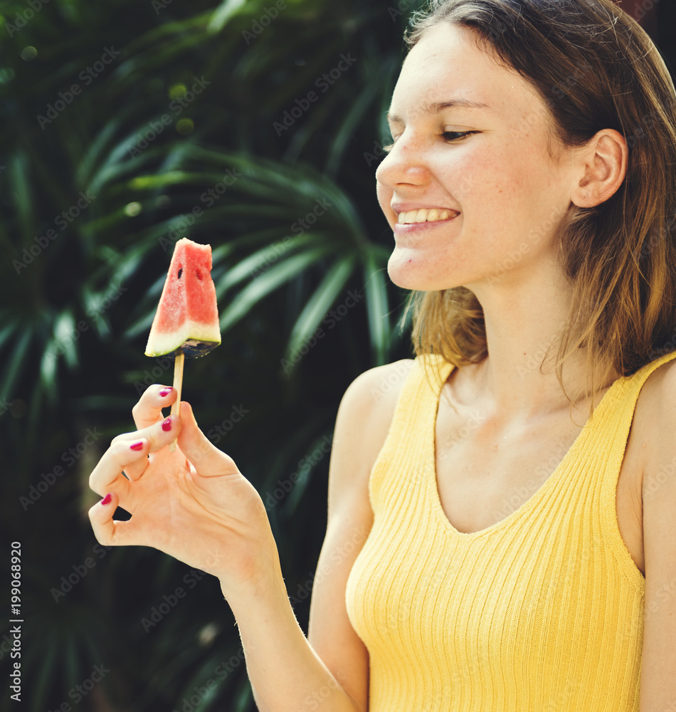 Caucasian woman eating watermelon in summertime