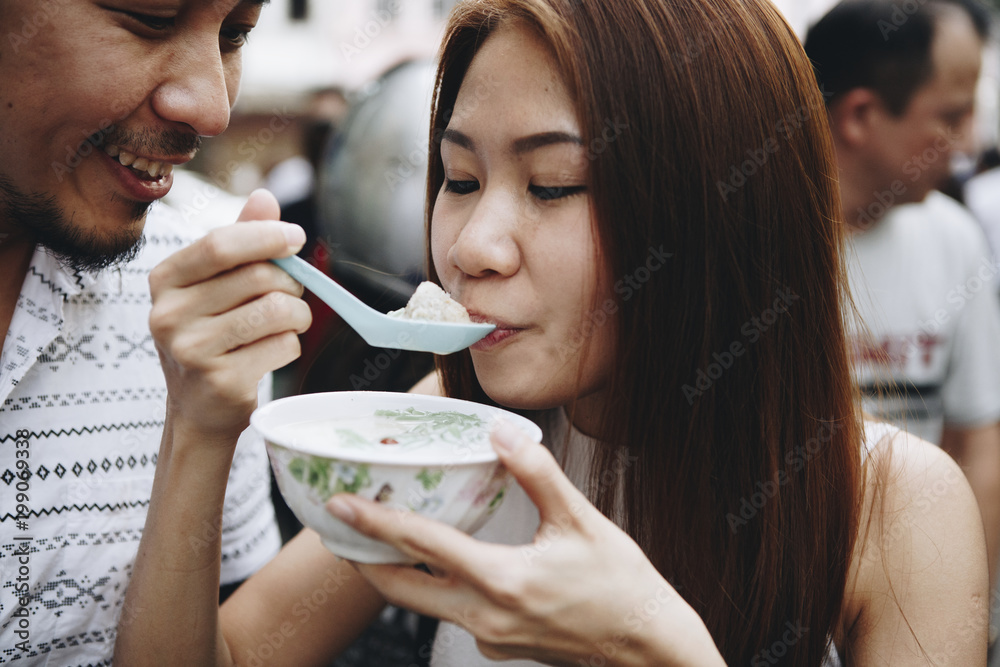 Woman having asian dessert outdoors