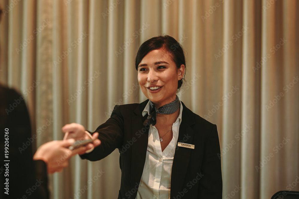 Receptionist receiving payment for hotel room from client