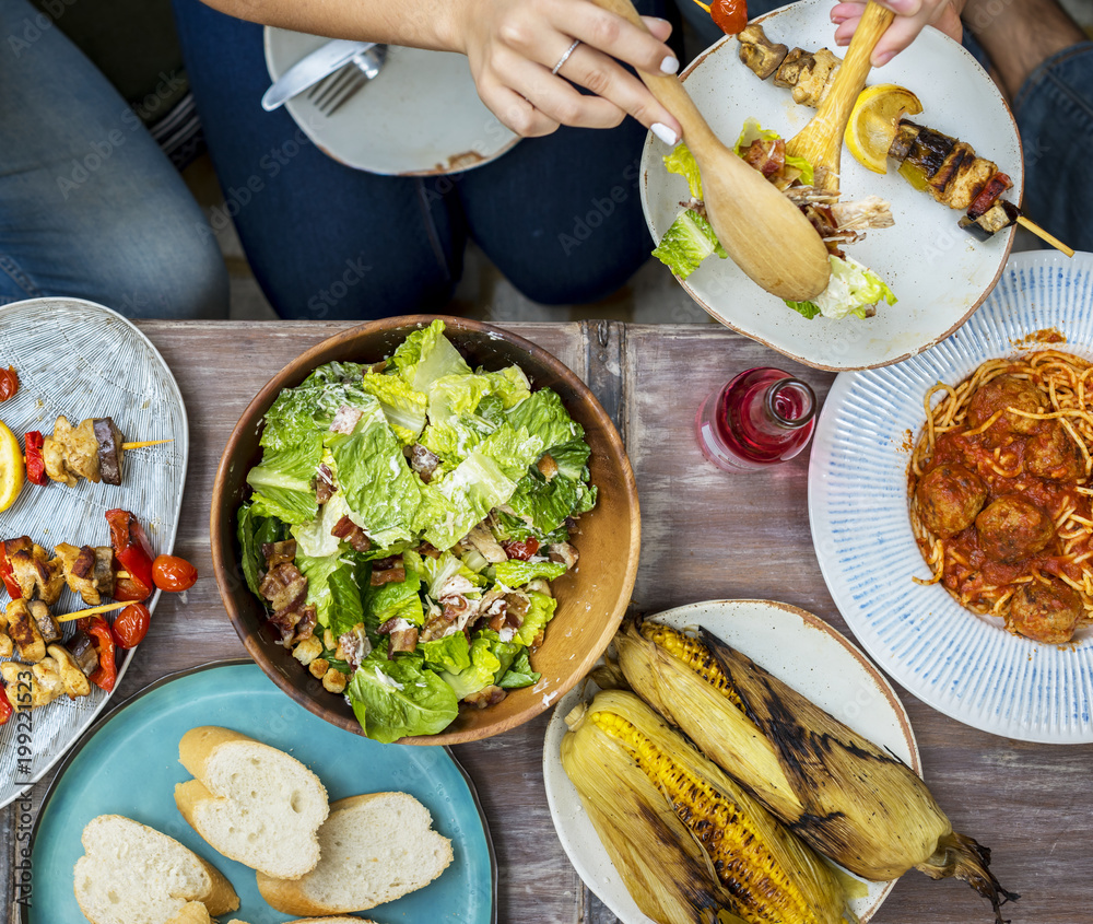 Diverse people eating food togethr