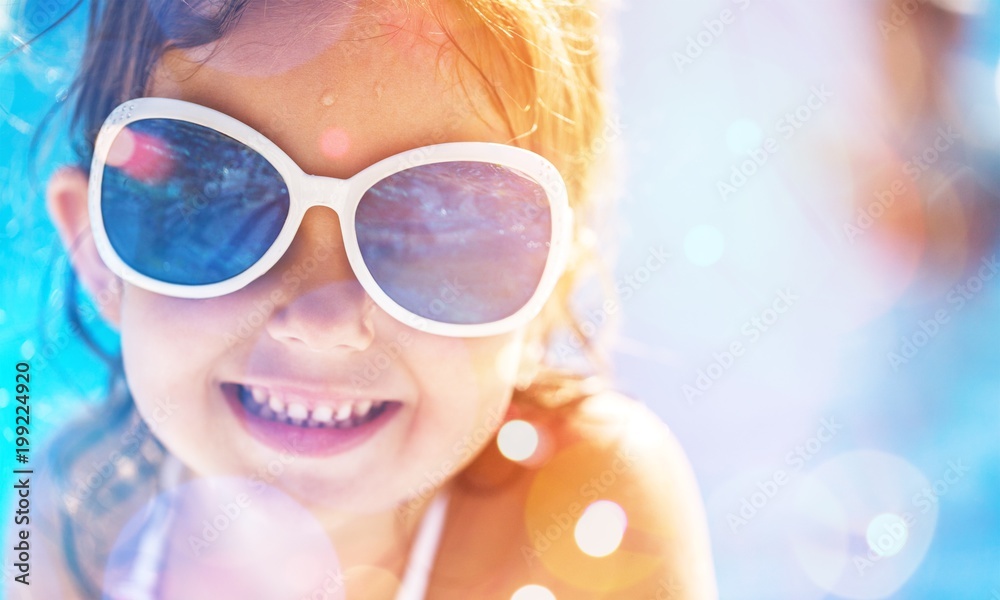 Beautiful little girl swimming at the pool