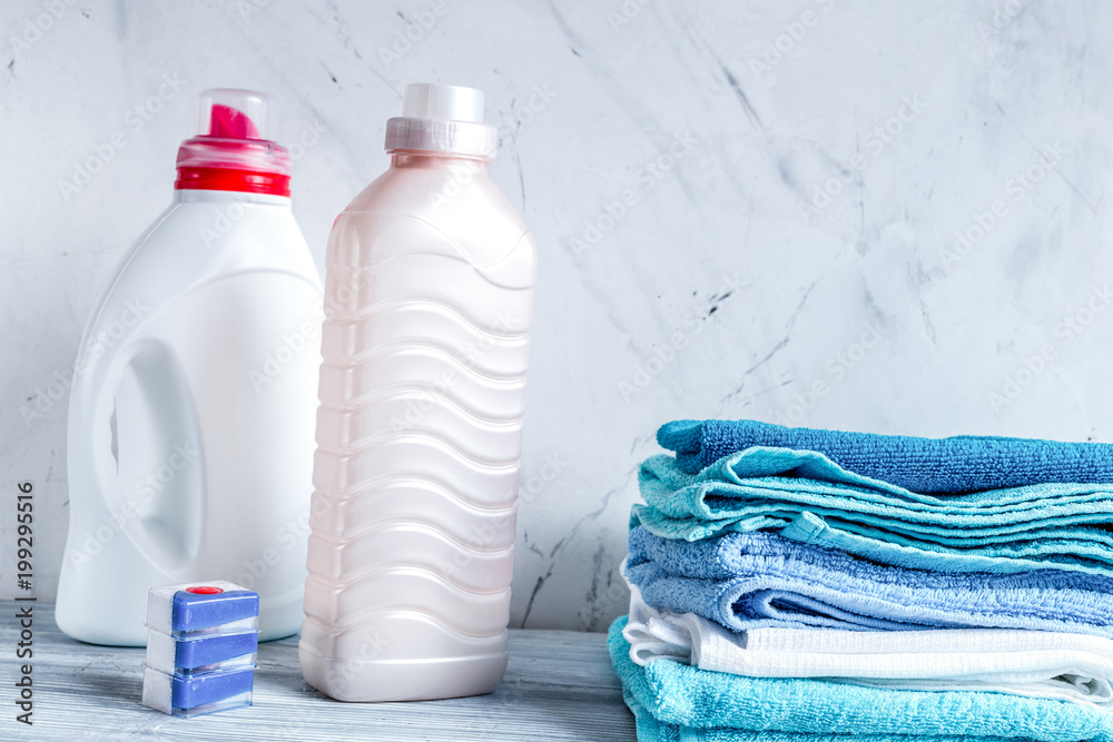 Towels pile with detergent and plastic bottles in laundry mockup