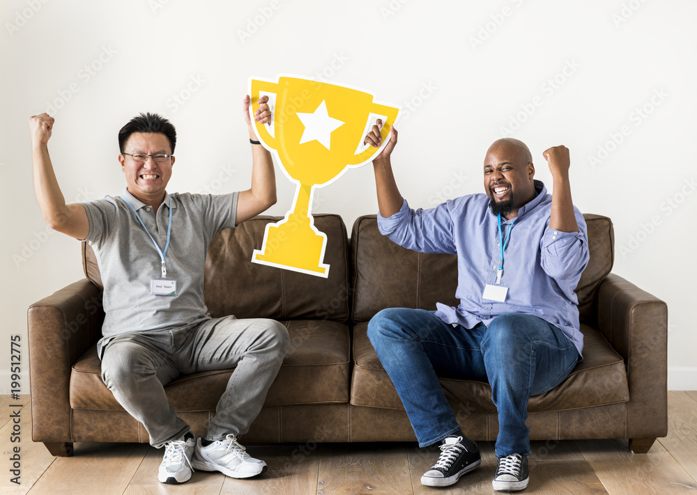 Men celebrating success with a trophy