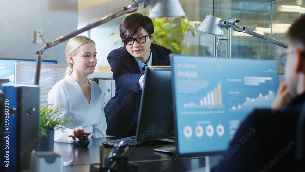 In the Office Businesswoman Sitting at Her Desk Talks with Her Сhef, theyre pointing at Computer Sc