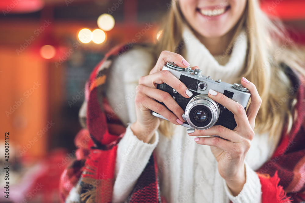 Smiling girl with retro camera