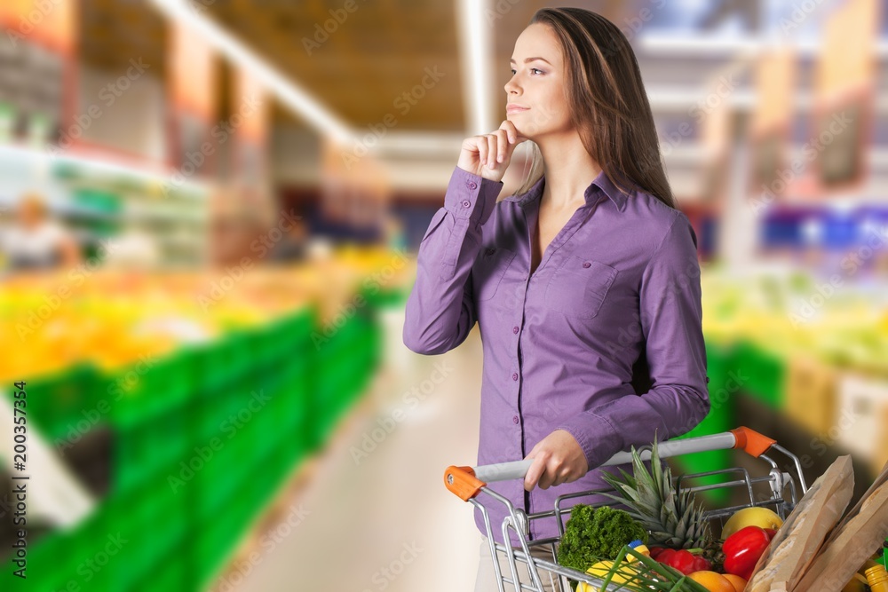 Young happy woman with shopping cart