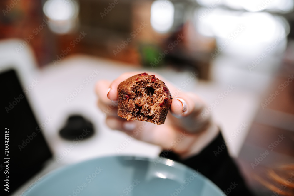 Eating cupcake. Close-up.