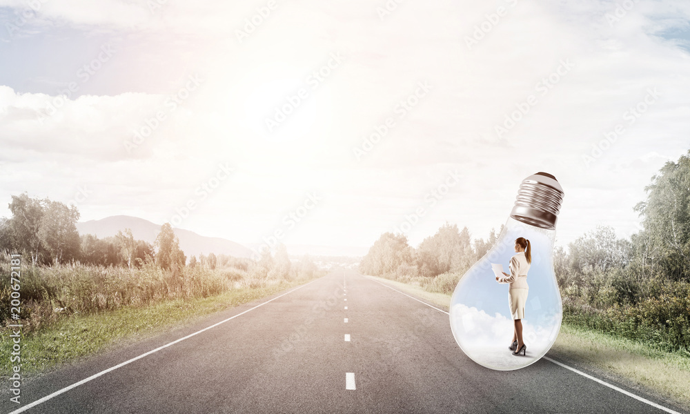 Businesswoman inside light bulb