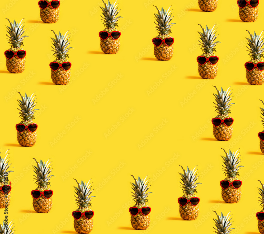 Series of pineapples wearing sunglasses on a yellow background