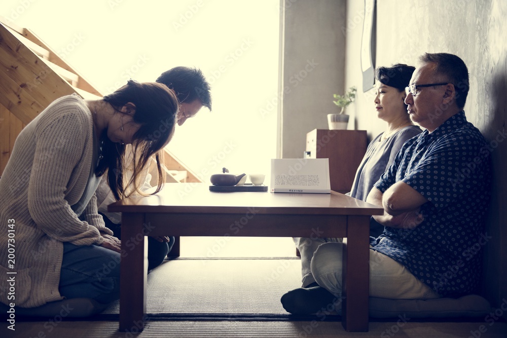 Japanese family greeting bowing with senior