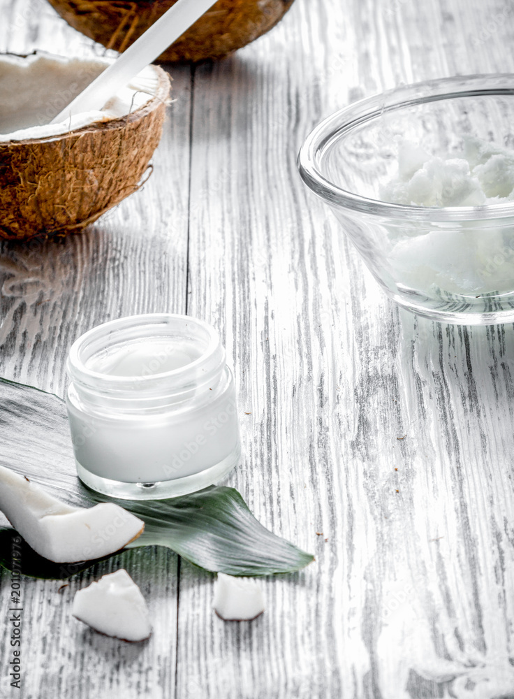 organic cosmetics with coconut on wooden background close up