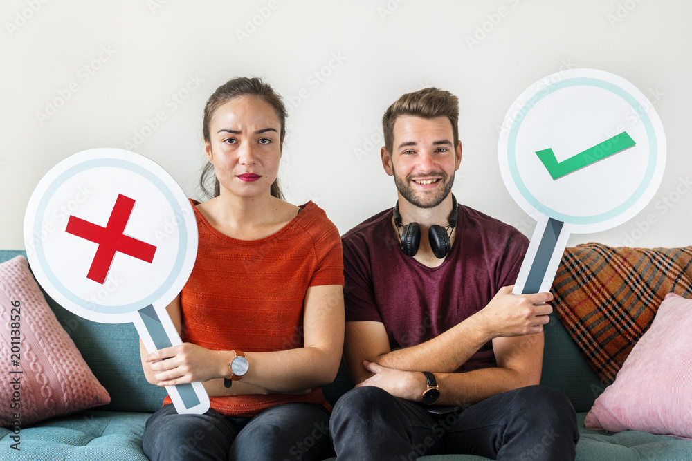 Couple showing yes and no sign