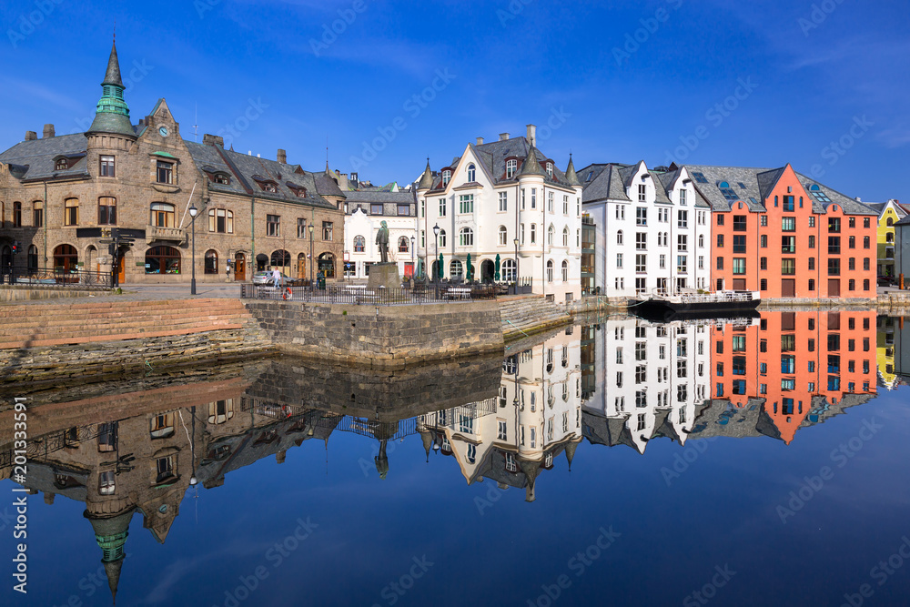 Architecture of Alesund town reflected in the water, Norway