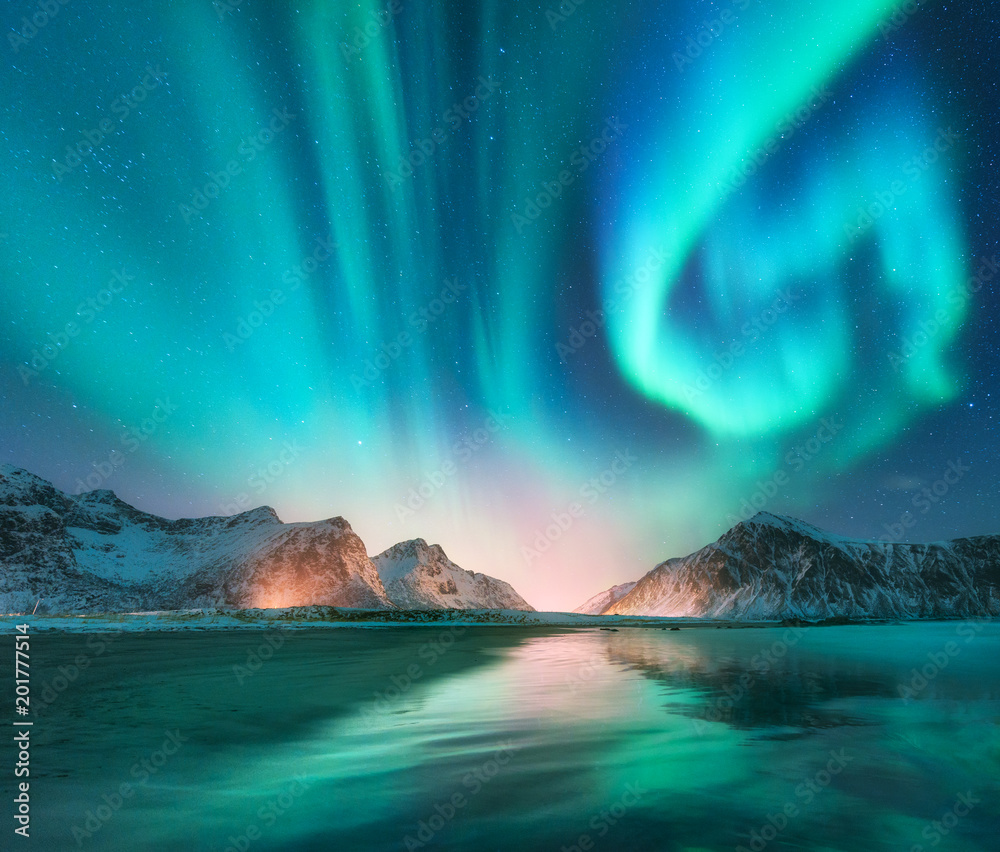 Aurora borealis in Lofoten islands, Norway. Aurora. Green northern lights. Starry sky with polar lig