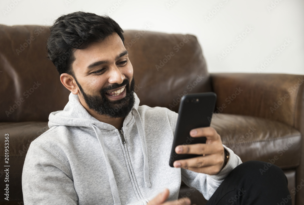 Happy man using mobile phone