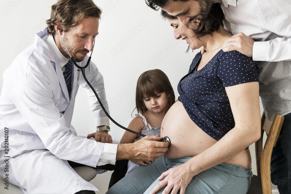 Pregnant woman having fetal monitoring by doctor