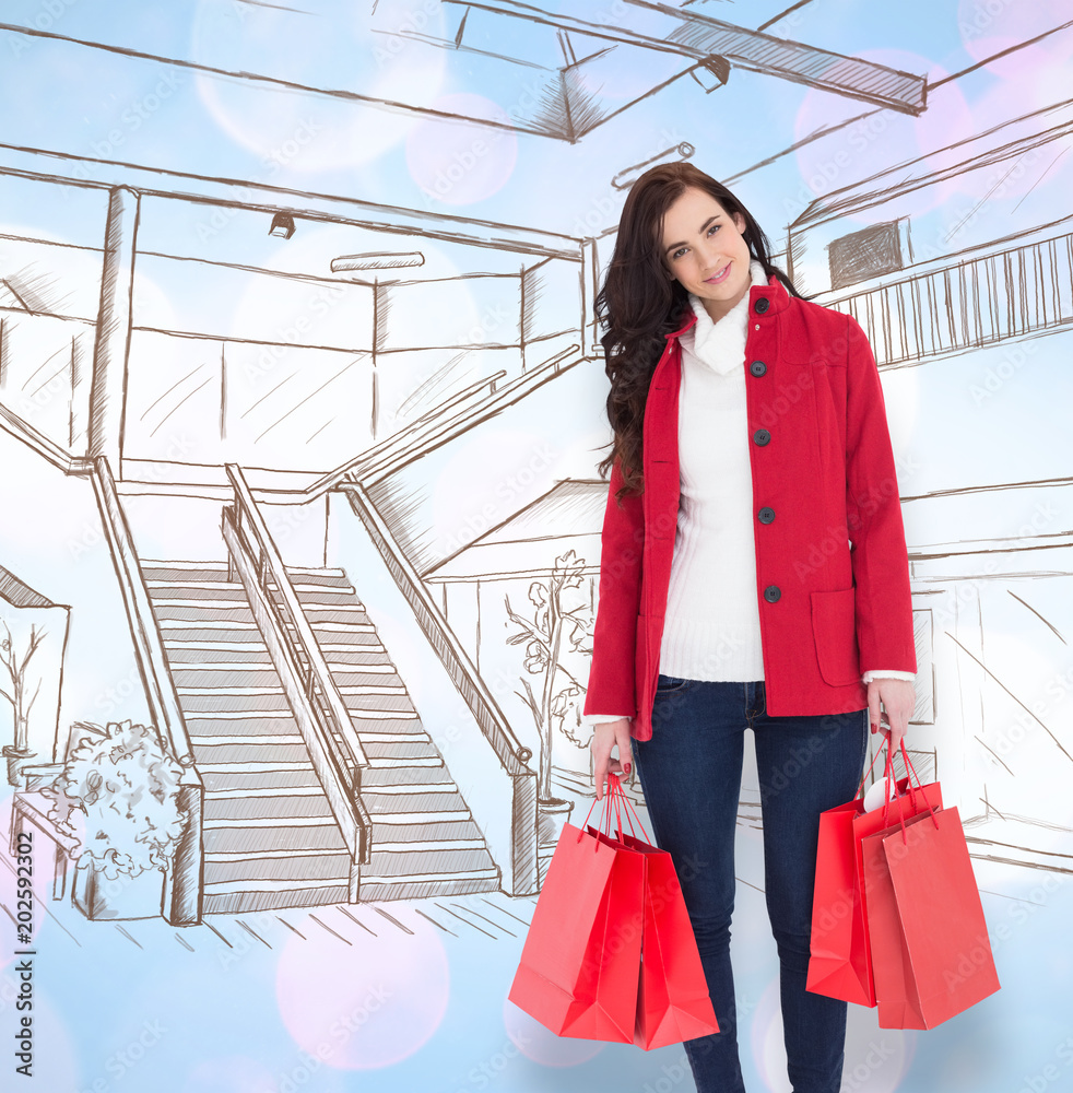 Smiling brunette in winter clothes holding shopping bags against twinkling yellow and purple lights