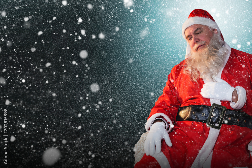 Santa Claus relaxing on chair against snow