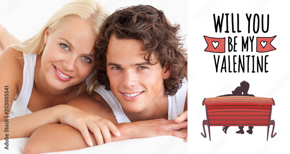 Couple lying on their bed against cute valentines message