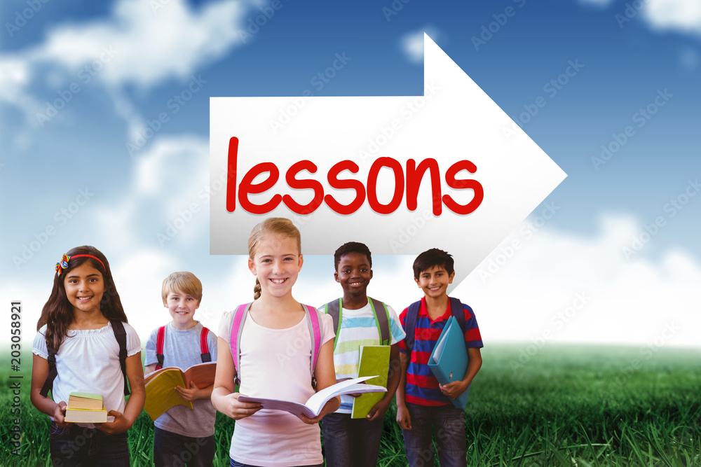 The word lessons and smiling little school kids in school corridor against blue sky over green field