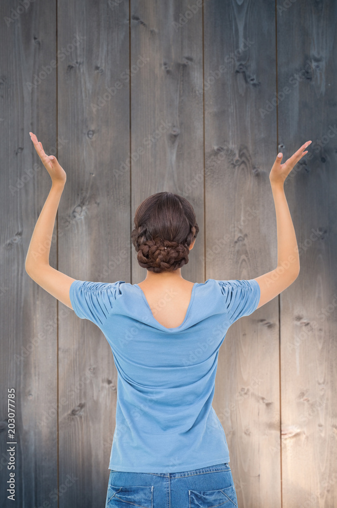 Brunette gesturing against bleached wooden planks background