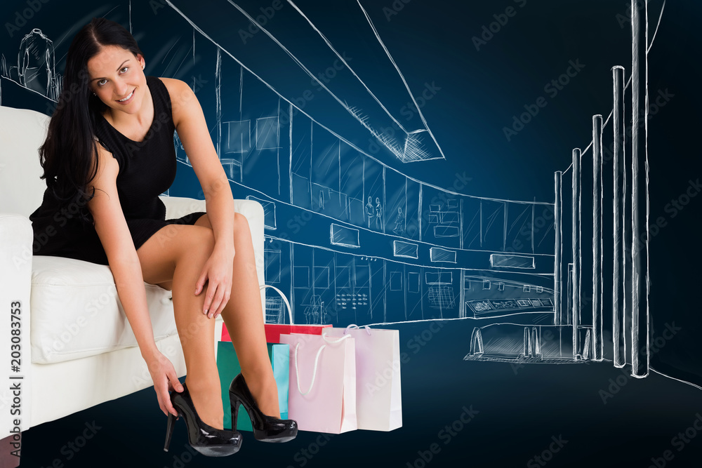 Woman sitting with shopping bags against blue background with vignette