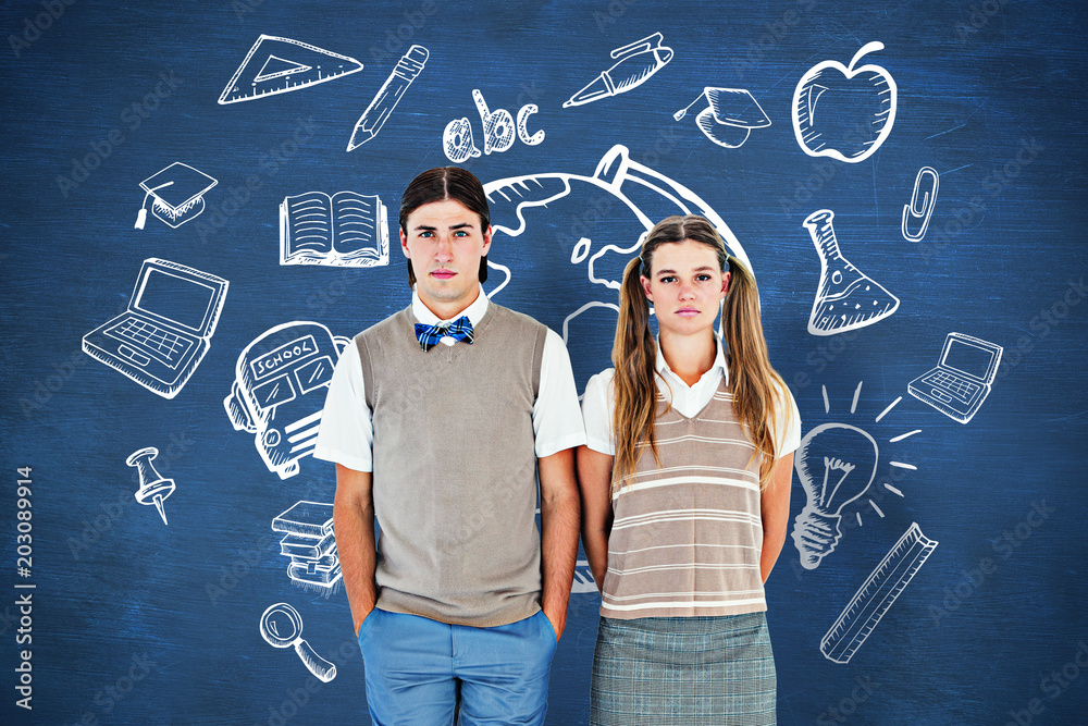 Unsmiling geeky hipsters looking at camera  against blue chalkboard