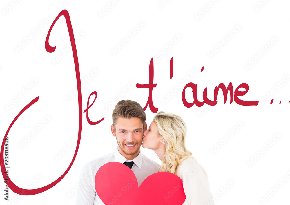 Attractive young couple holding red heart against valentines love hearts