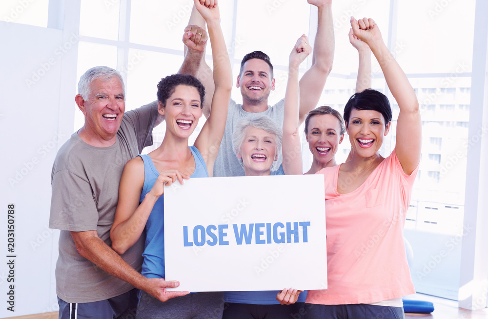 The word lose weight against portrait of happy fit people holding blank board