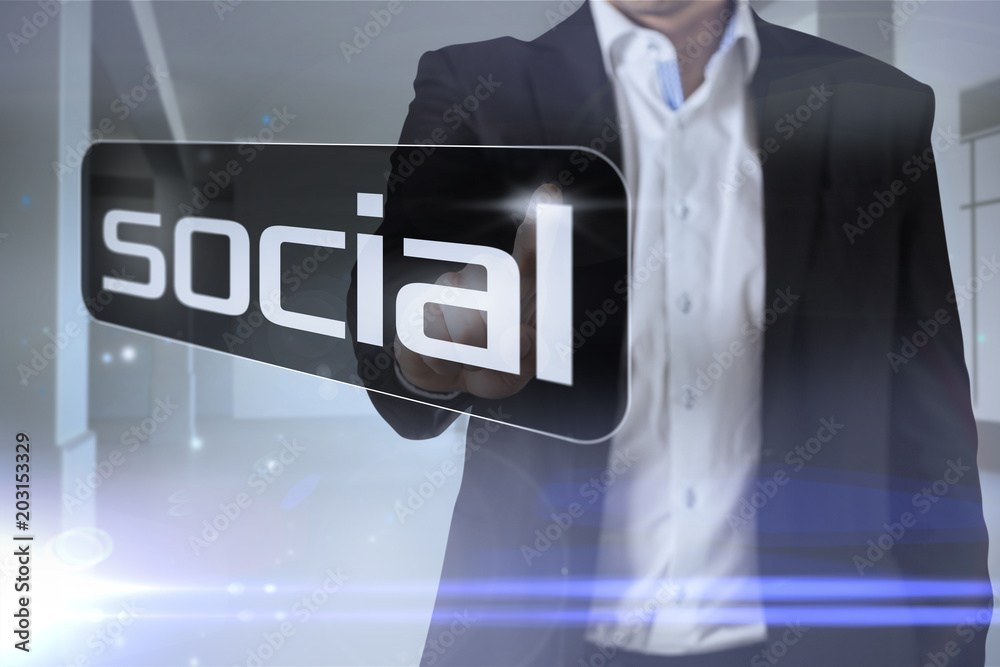 Businessman pointing to word social against screen in room with sparks