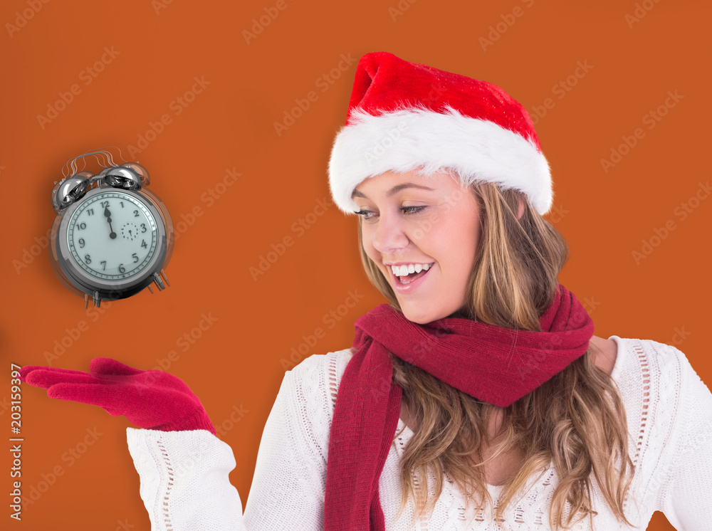 Festive blonde presenting with hand against room with wooden floor