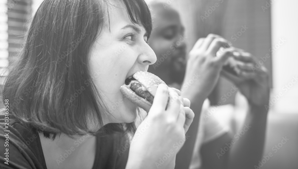 Couple having fast food on the couch