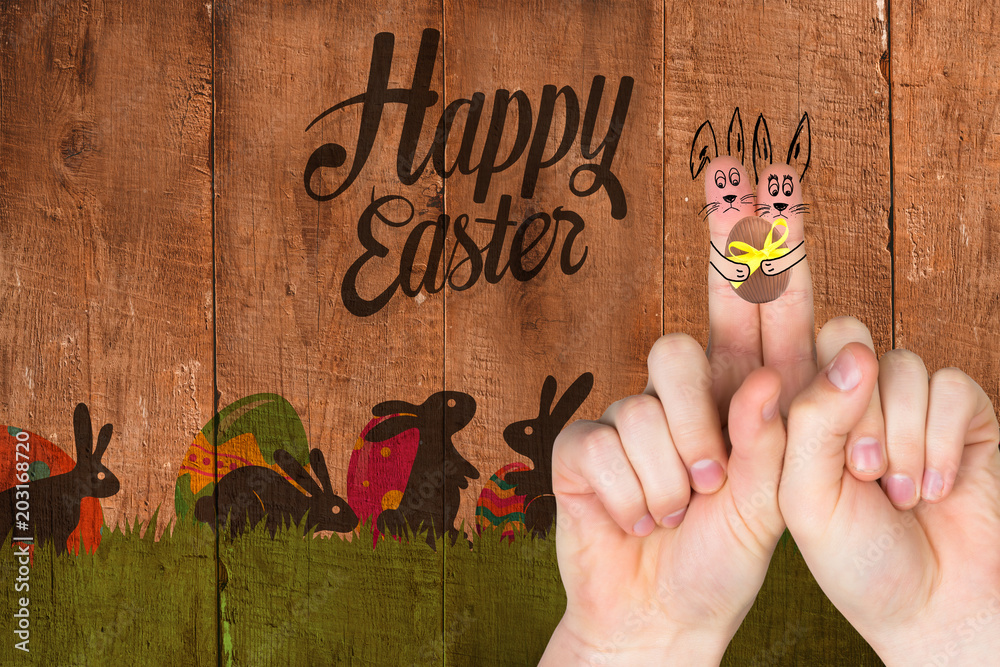 Fingers as easter bunny against wooden planks