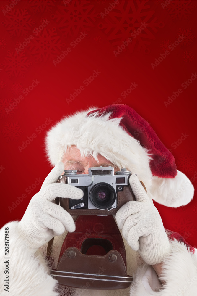 Santa is taking a picture against red background